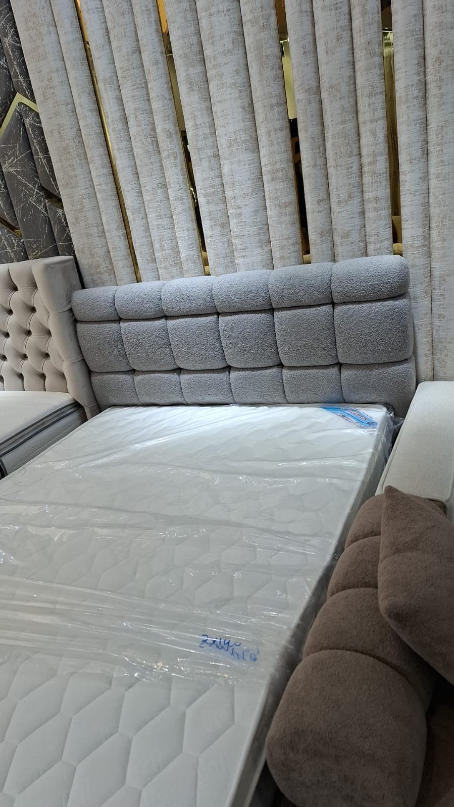 Grey bouclé panel headboard — showroom