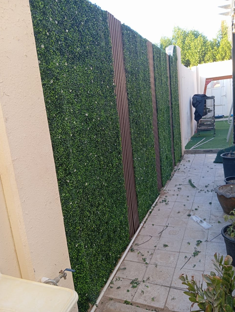 Artificial hedge wall with timber slat dividers